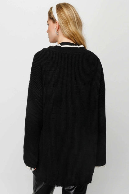 Modest fashion zwarte vest – grofgebreid, lang model met zakken
